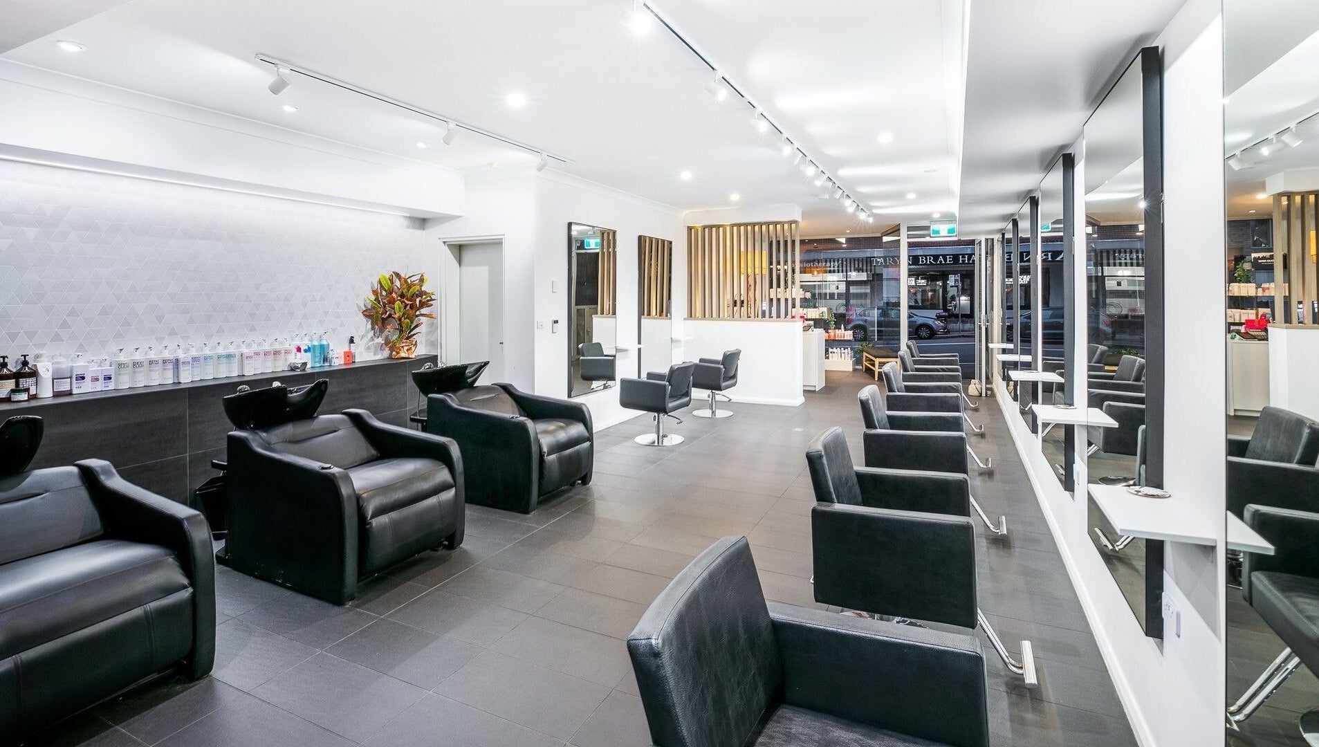 Modern interior of BAE Salon with sleek chairs and mirrors in Woolooware, New South Wales, AU.