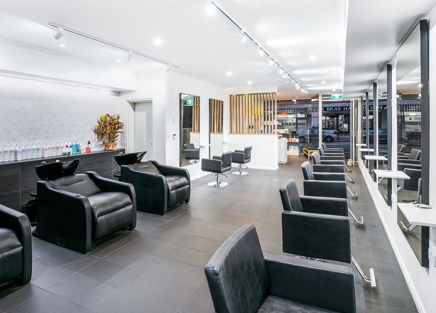 Modern interior of BAE Salon with sleek chairs and mirrors in Woolooware, New South Wales, AU.