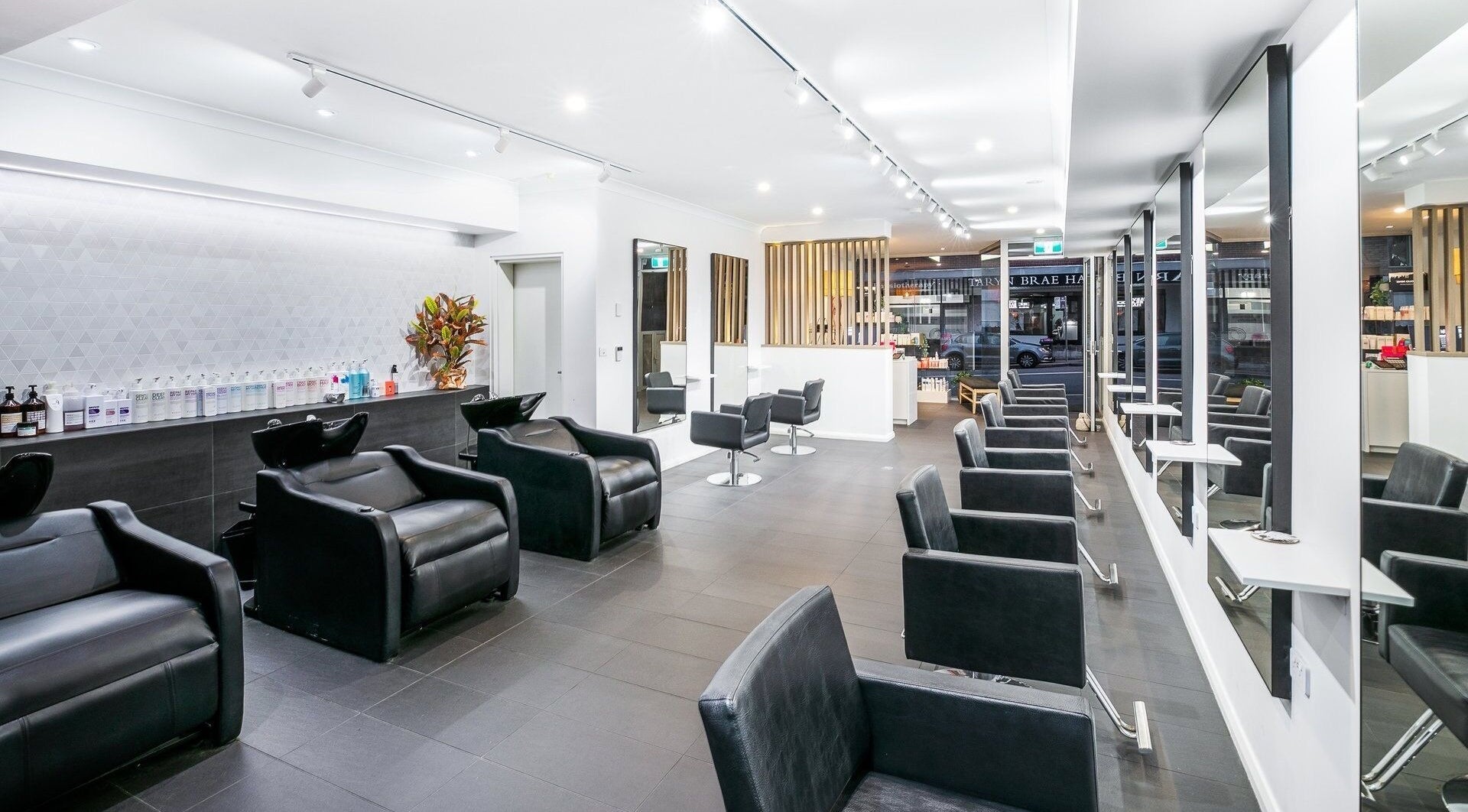 Modern interior of BAE Salon with sleek chairs and mirrors in Woolooware, New South Wales, AU.