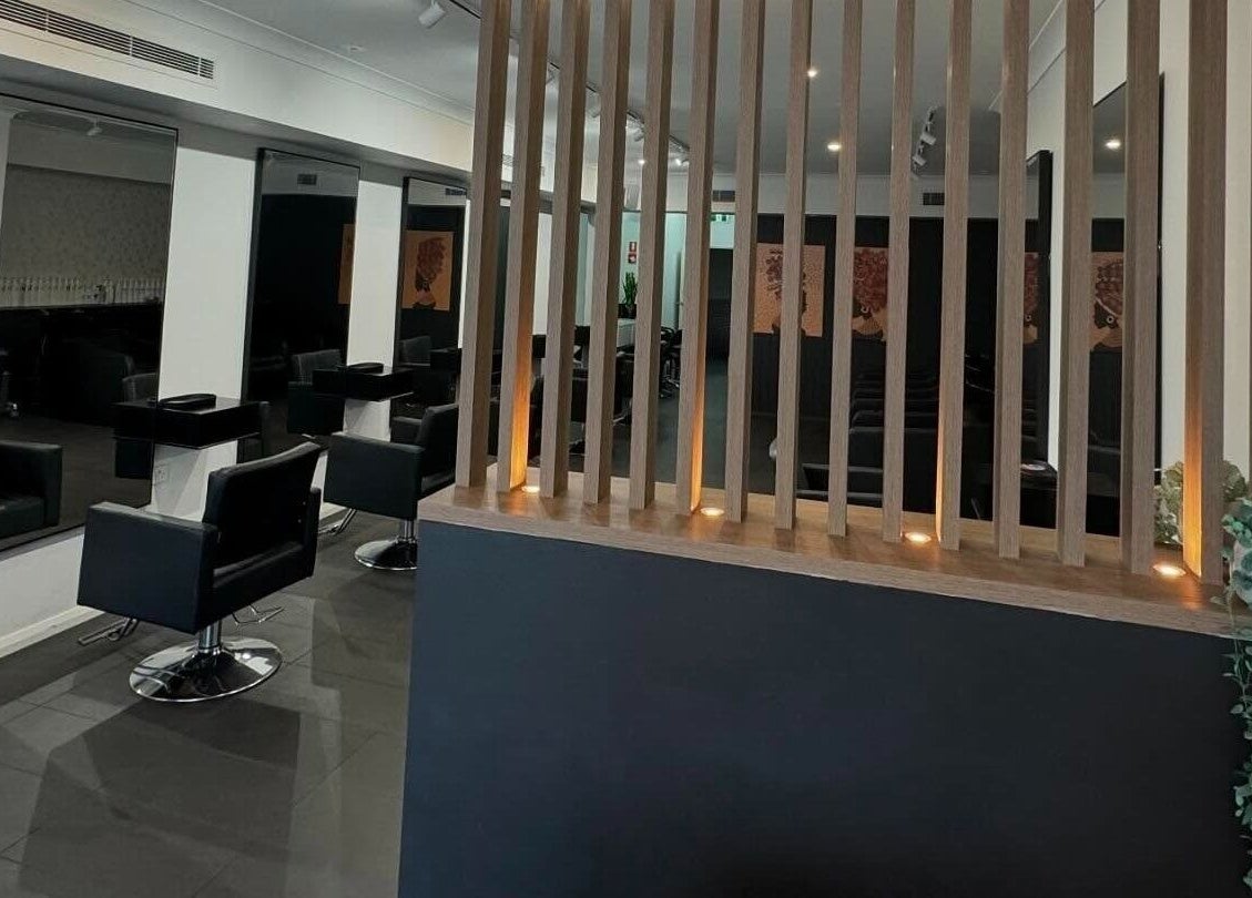Modern interior of BAE Salon, Woolooware, New South Wales, AU featuring sleek black chairs and mirrors.