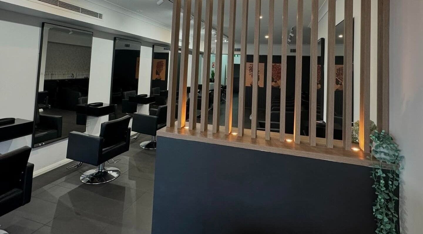 Modern interior of BAE Salon, Woolooware, New South Wales, AU featuring sleek black chairs and mirrors.