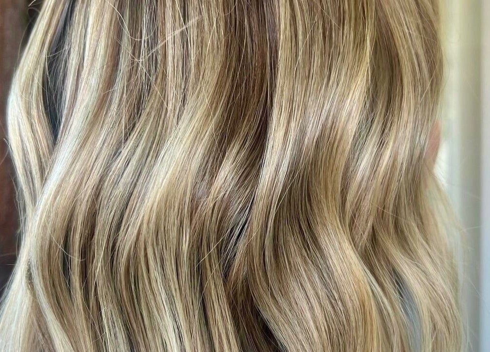 Close-up of flowing blonde hair in soft waves at BAE Salon, Woolooware, New South Wales, AU.
