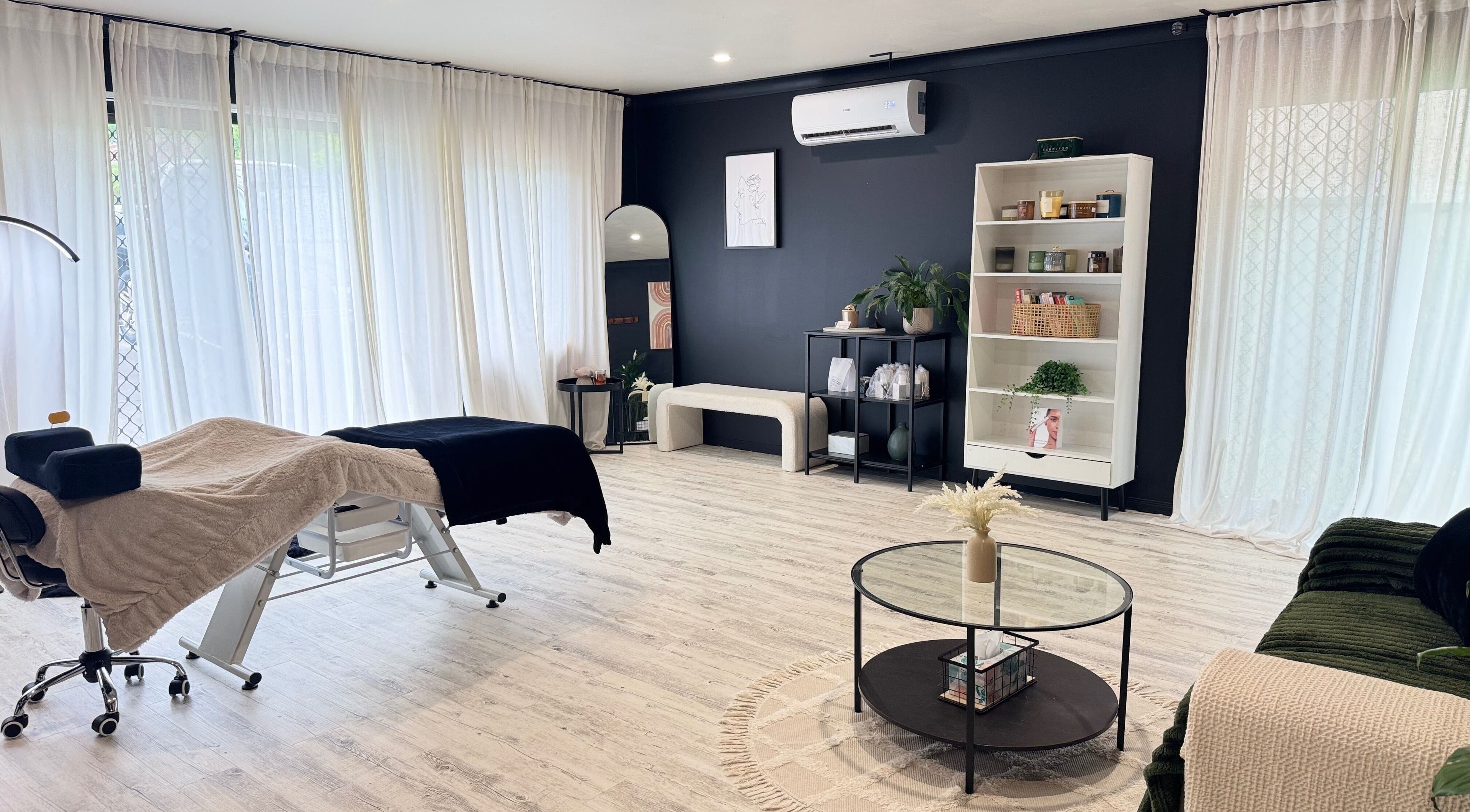 Spacious and serene wellness venue at Astrid & Ko, Redbank Plains, Queensland, AU with massage bed and elegant decor.