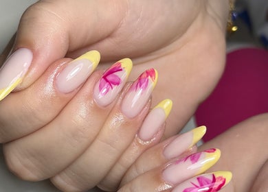 Vibrant floral nail art with yellow tips at Nails by Oliwia, Ellesmere Port, England, GB.
