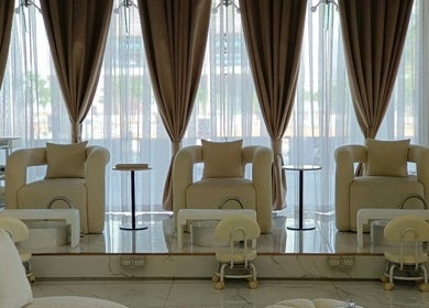 Luxurious pedicure lounge at Palm Aura Beauty Salon, Dubai, Dubai, AE, with elegant cream decor and natural light.