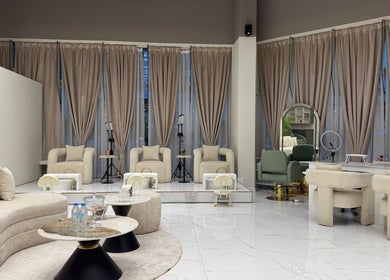 Elegant interior of Palm Aura Beauty Salon in Dubai, Dubai, AE with plush seating and chic decor.