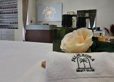 Palm Aura Beauty Salon interior with elegant décor in Dubai, Dubai, AE featuring towels, rose, and products.