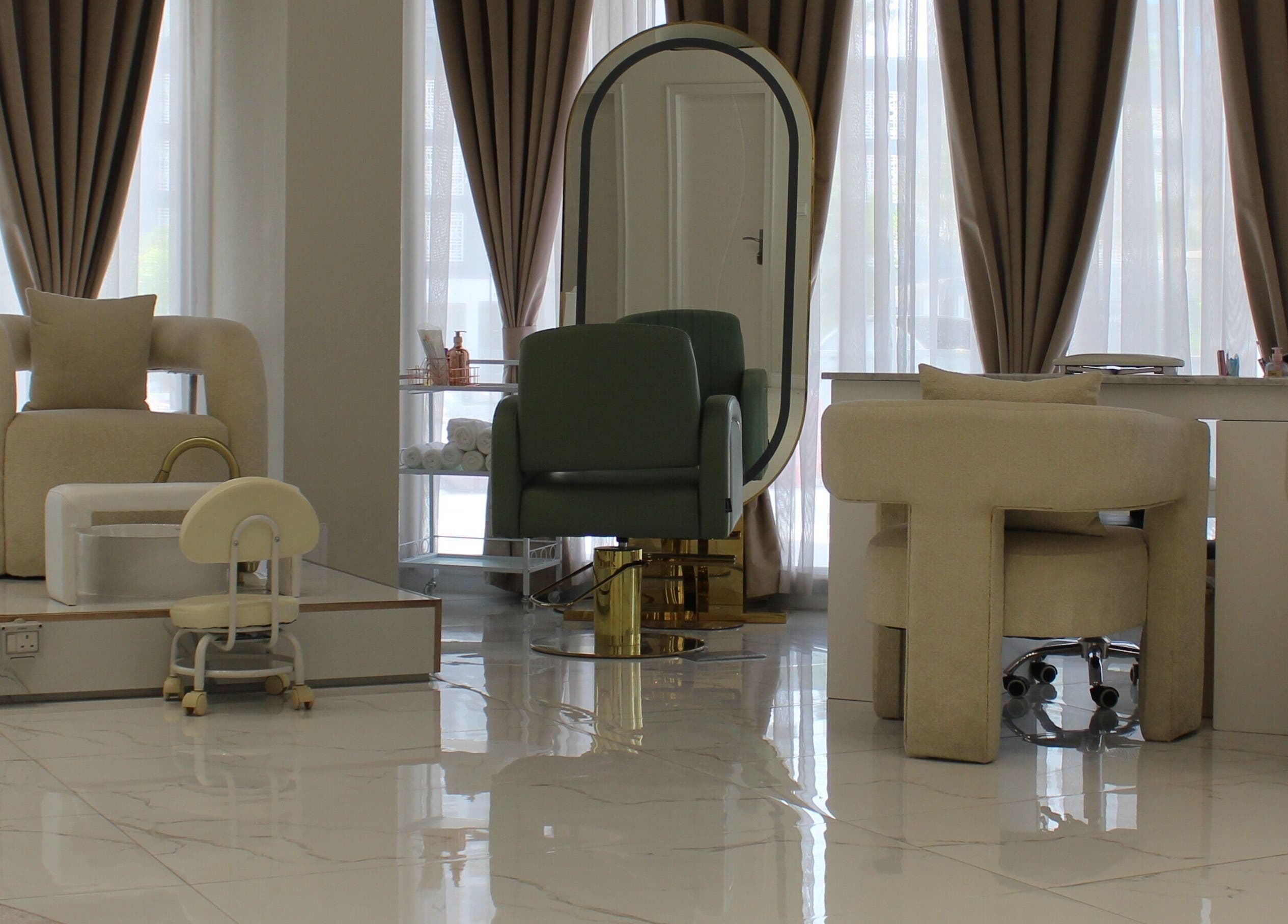 Chic interior of Palm Aura Beauty Salon, Dubai, featuring elegant seating and large mirror.