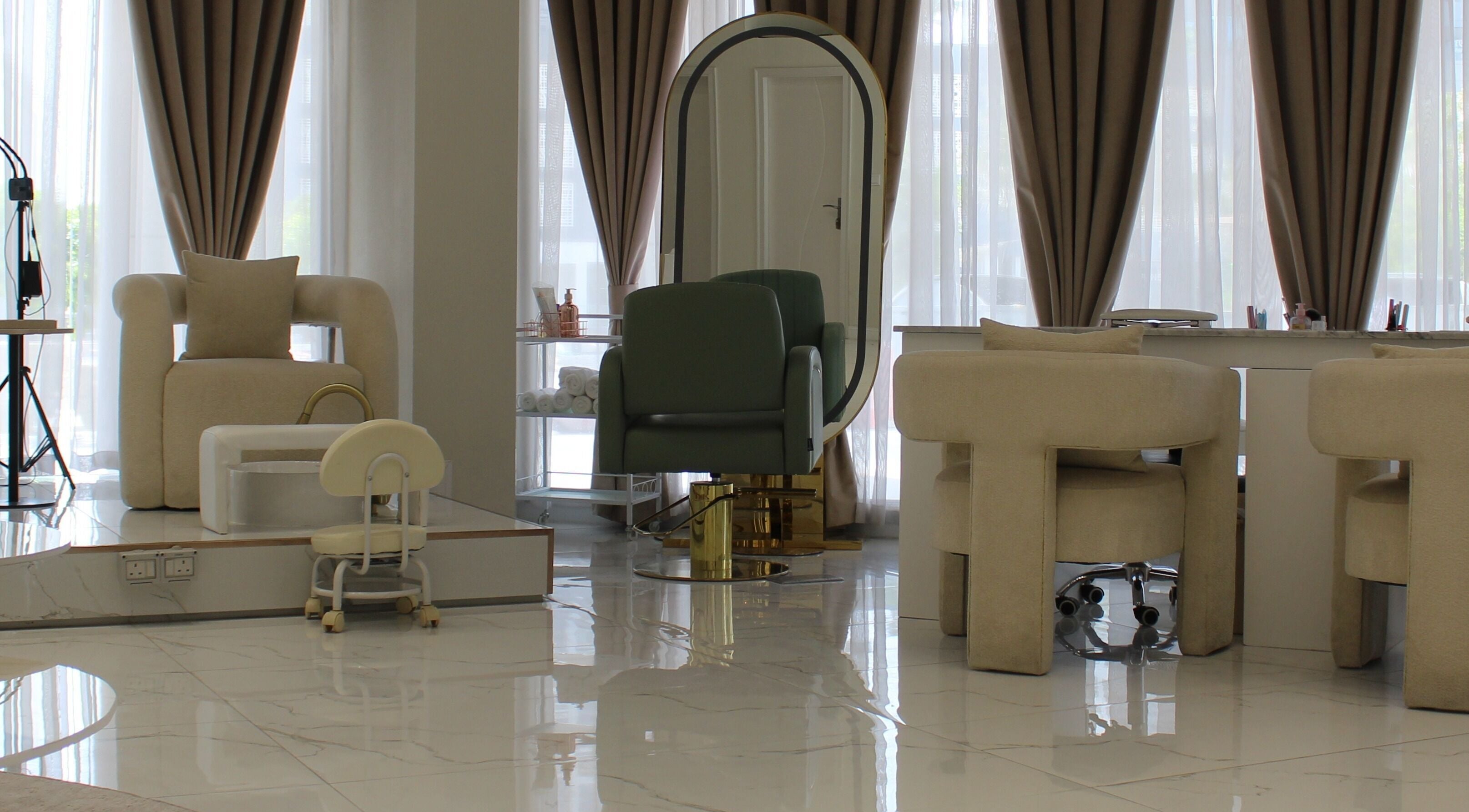 Chic interior of Palm Aura Beauty Salon, Dubai, featuring elegant seating and large mirror.