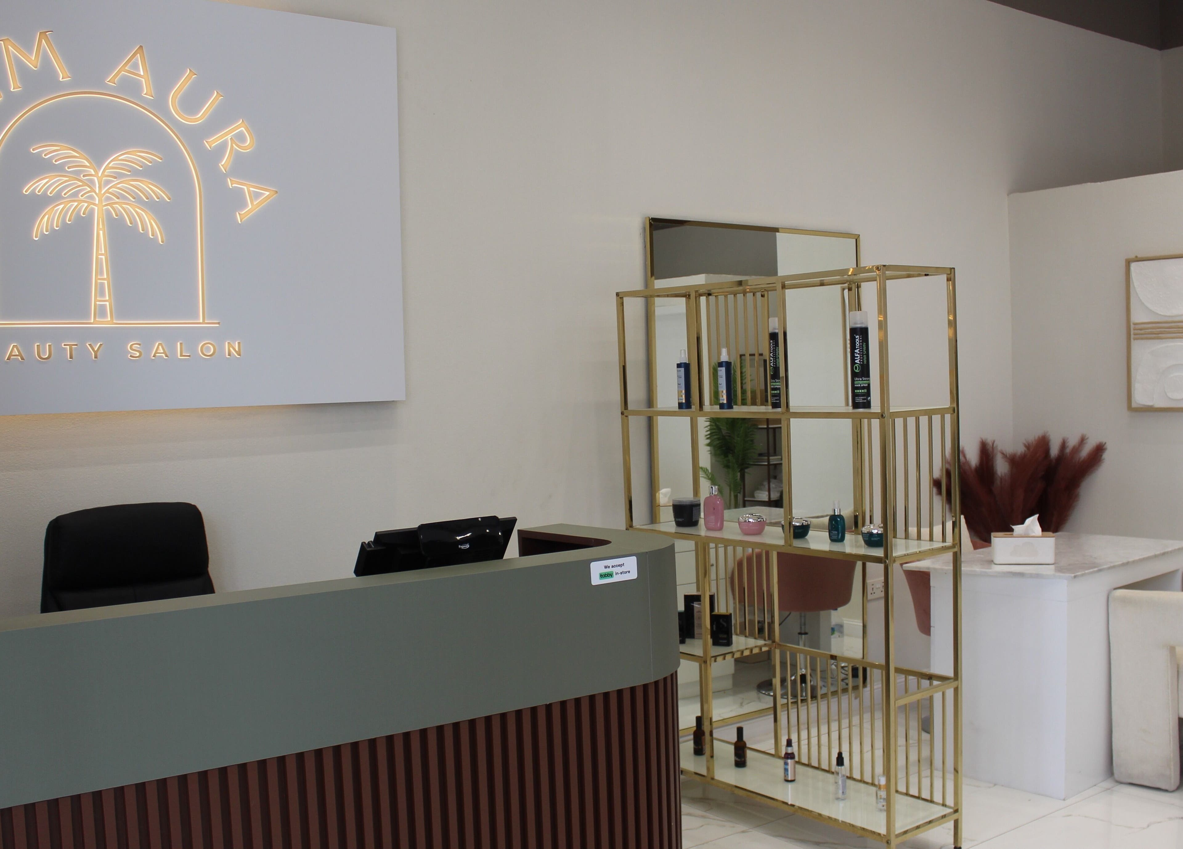 Reception area at Palm Aura Beauty Salon, Dubai, Dubai, AE featuring stylish decor and product display.