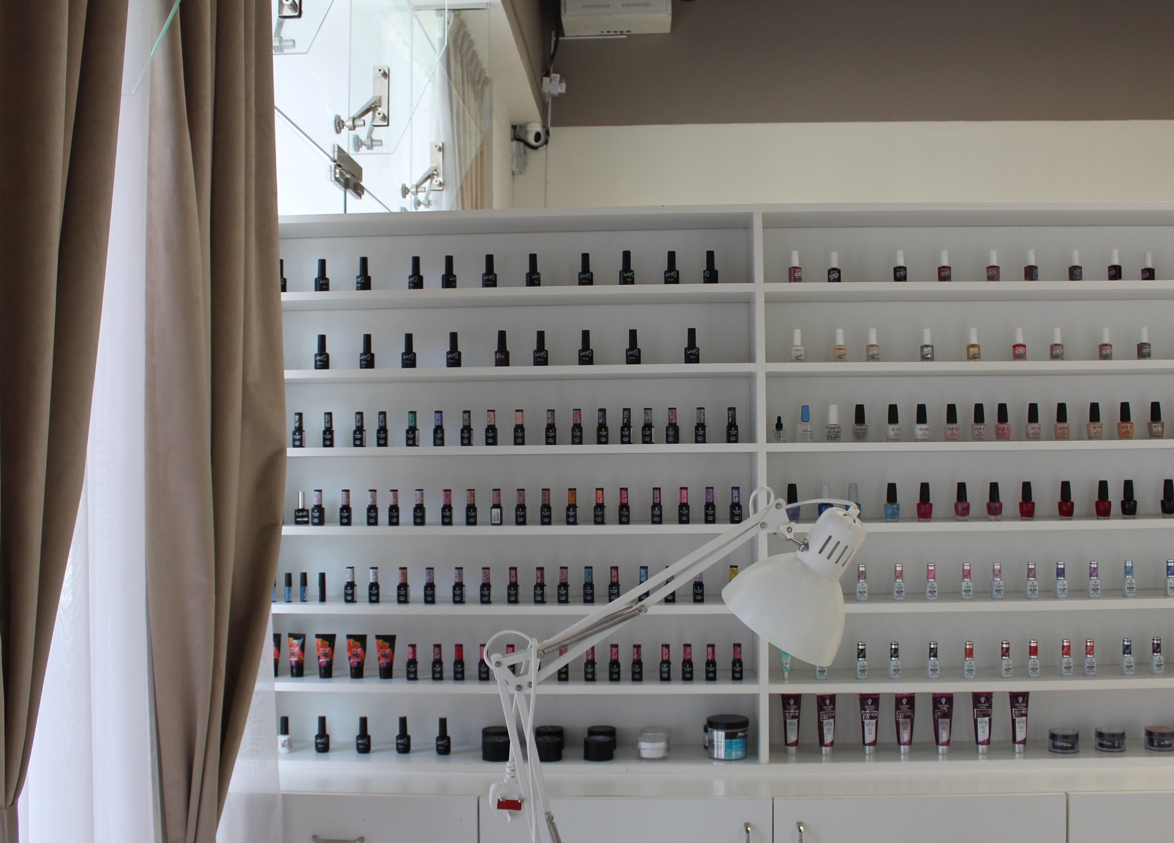 Nail polish display at Palm Aura Beauty Salon, Dubai, Dubai, AE, showcasing diverse color selection.