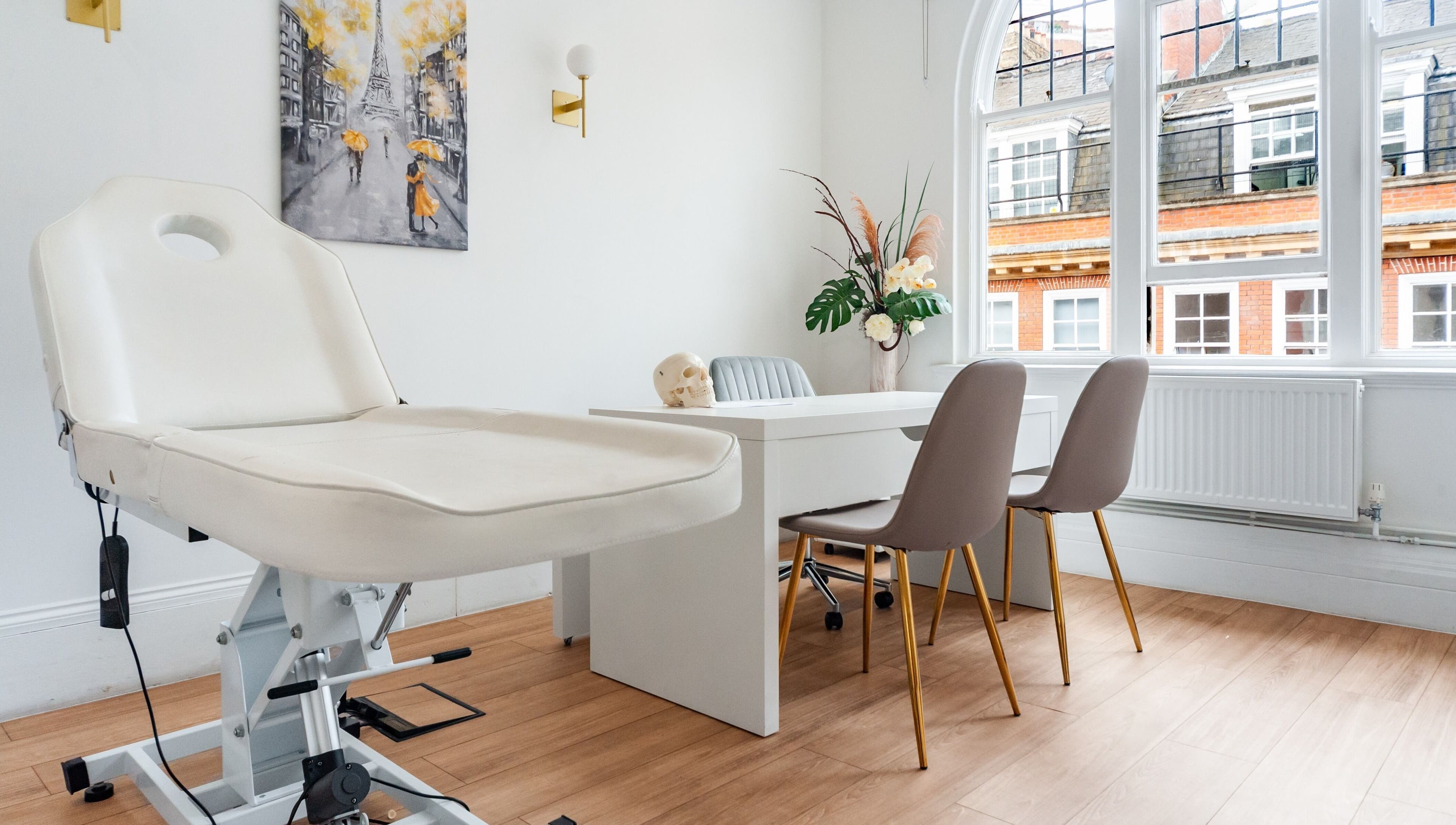 Trikwan Aesthetics treatment room in London, England, GB with modern decor and comfortable seating.