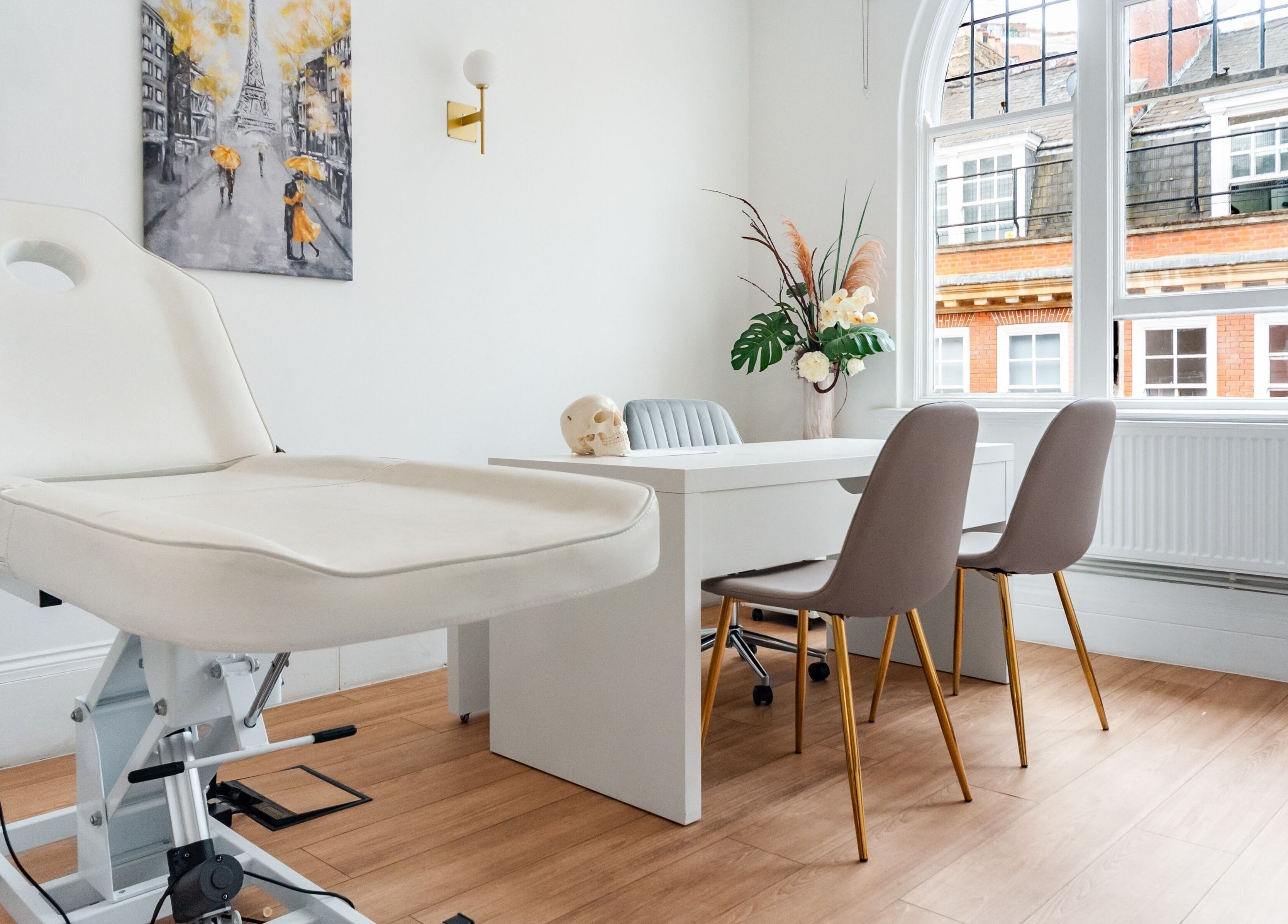 Trikwan Aesthetics treatment room in London, England, GB with modern decor and comfortable seating.