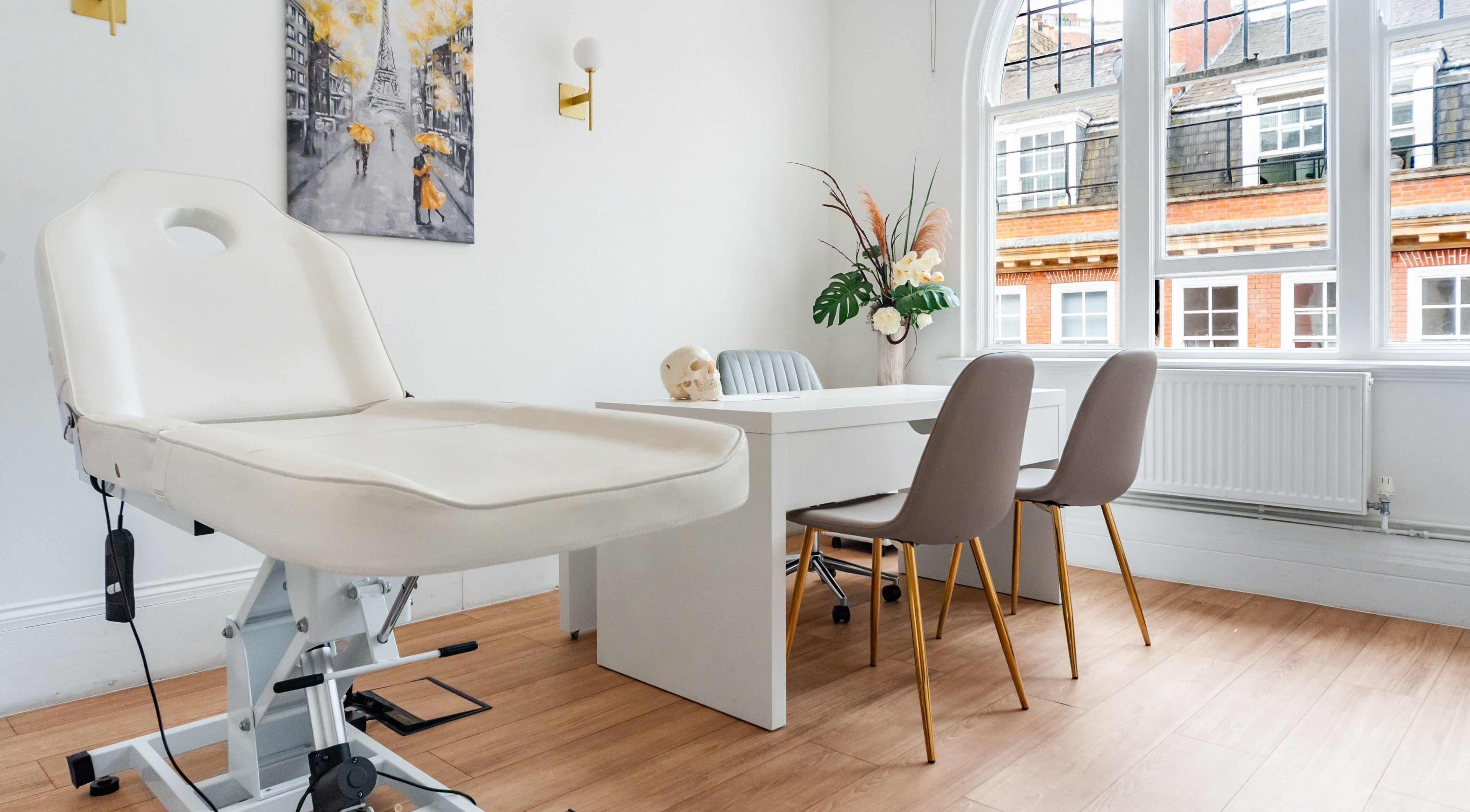 Trikwan Aesthetics treatment room in London, England, GB with modern decor and comfortable seating.