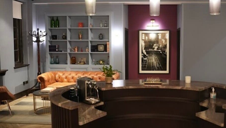 Elegant reception at Lilium Aesthetic Clinic, London, England with chic decor and plush seating.