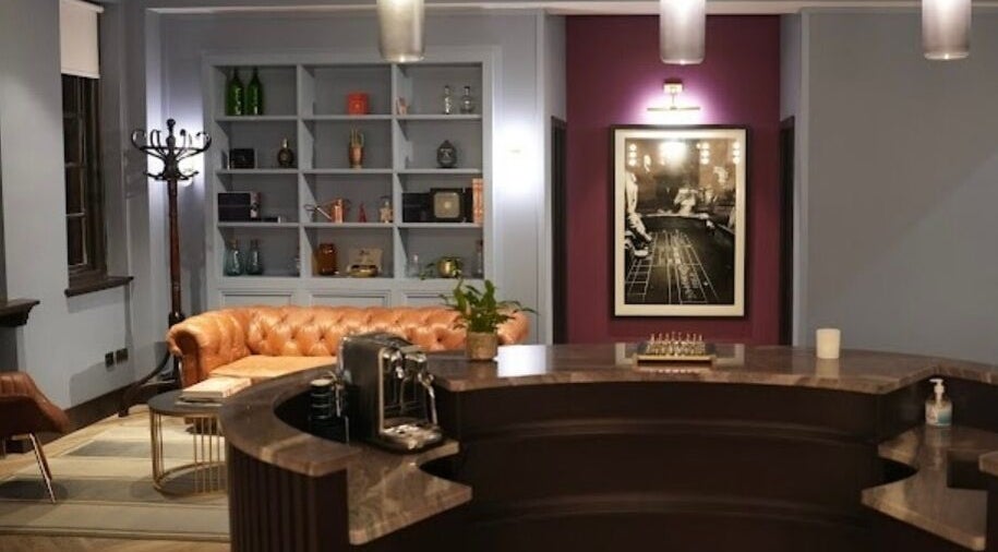 Elegant reception at Lilium Aesthetic Clinic, London, England with chic decor and plush seating.