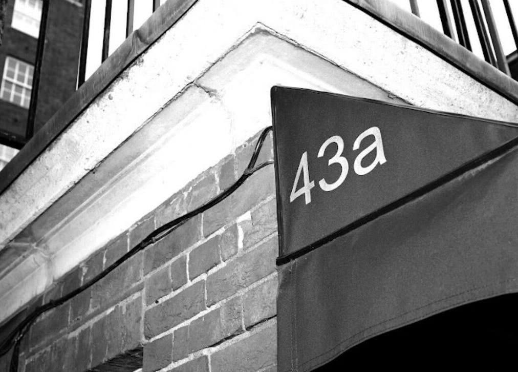 Entrance to Lilium Aesthetic Clinic, 43a London, England, GB, showcasing brick walls and signage.