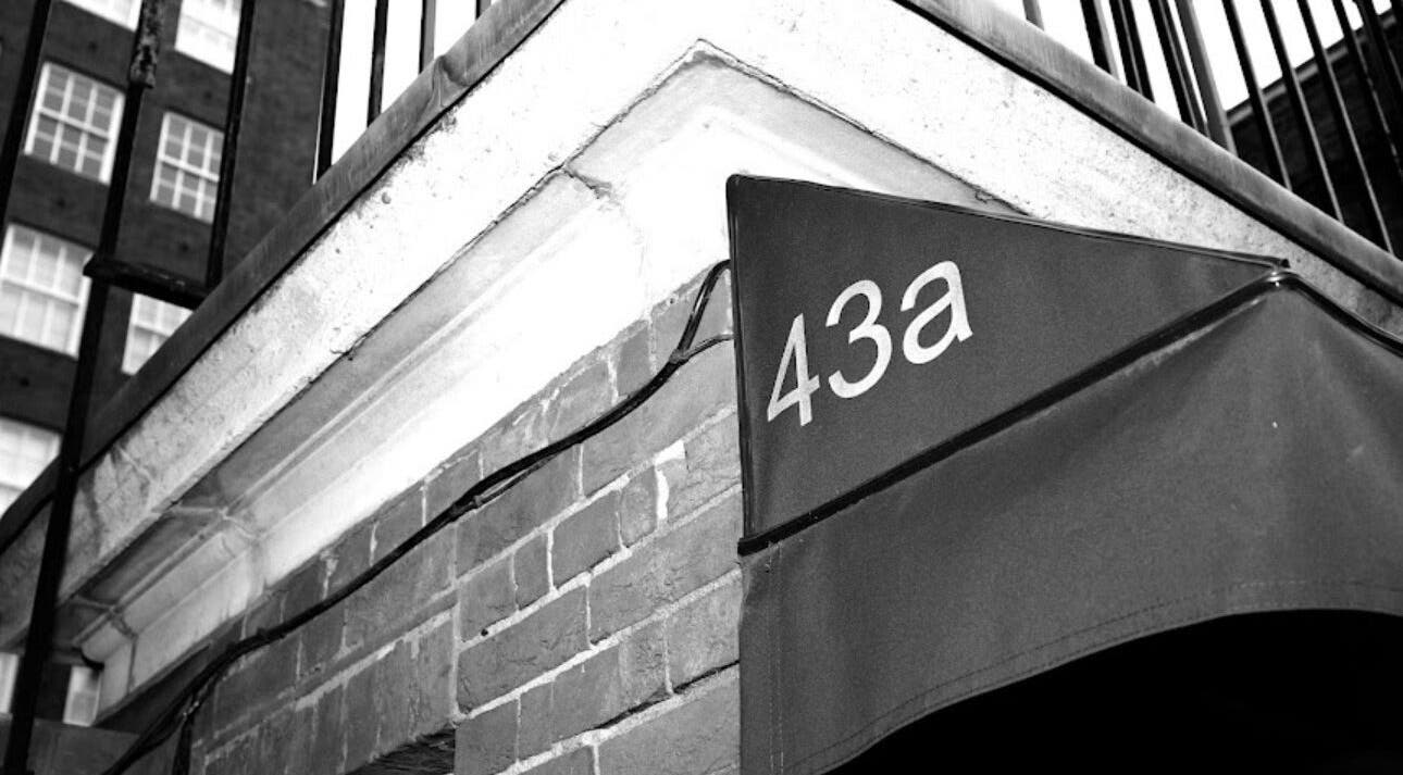 Entrance to Lilium Aesthetic Clinic, 43a London, England, GB, showcasing brick walls and signage.