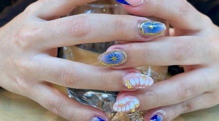 Manicura cósmica en Calma Nail Bar - Condesa, Ciudad De México, MX. Diseño azul con detalles dorados.