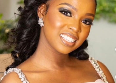 Smiling woman with styled hair at La Beaute by Carine, Randburg, Gauteng, ZA.