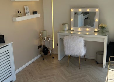 Chic vanity setup at The Beauty Atelier Stalbans, St Albans, England, GB with a lit mirror and plush chair.