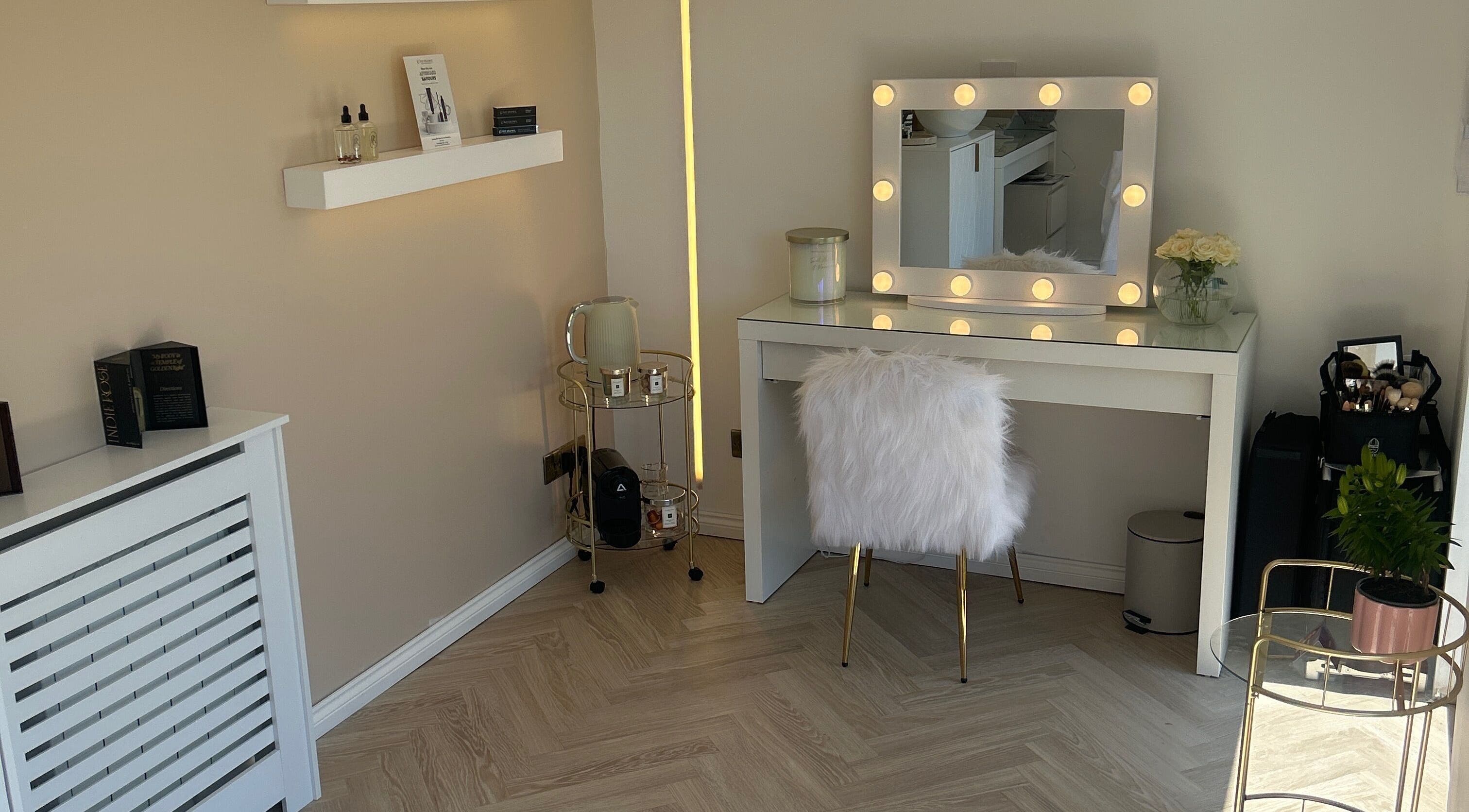 Chic vanity at The Beauty Atelier Stalbans, St Albans, England, GB with lighted mirror and fluffy chair.