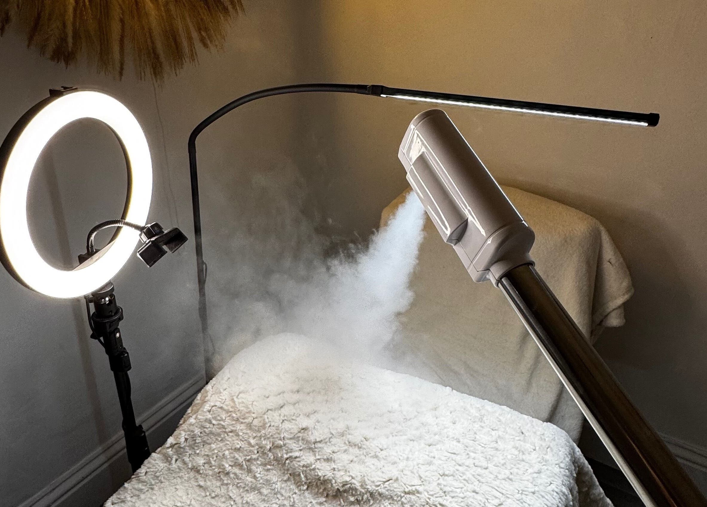 Cozy treatment room at Luminous with Lil in Barrow-in-Furness, England with steam and ring light.