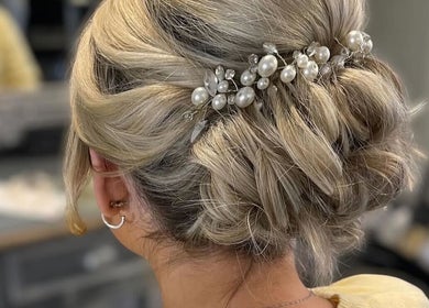 Elegant updo adorned with pearls at Gloss Glo & Blo, Paisley, Scotland, GB.