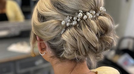Elegant updo adorned with pearls at Gloss Glo & Blo, Paisley, Scotland, GB.