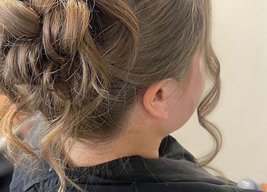 Chic updo hairstyle at Gloss Glo & Blo in Paisley, Scotland, GB. Perfect for weddings or special events.