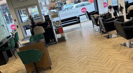 Gloss Glo & Blo salon interior in Paisley, Scotland, GB, featuring modern black and green seating and large windows.
