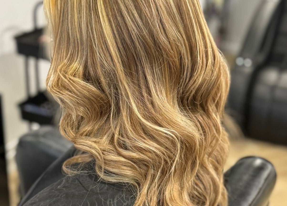 Elegant blonde waves styled at Gloss Glo & Blo, Paisley, Scotland, GB. Experience luxurious hair transformations.
