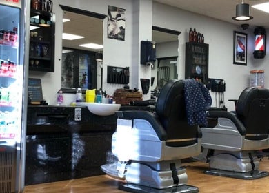 Interior of Paul's Hairdressing for Men in Wallsend, England, GB with barber chairs and grooming tools.