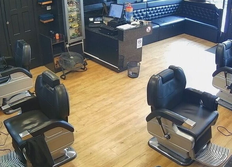 Interior view of Paul's Hairdressing for Men, Wallsend, England, GB, featuring modern barber chairs and stylish decor.