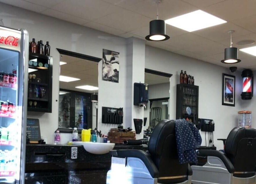 Inside Paul's Hairdressing for Men in Wallsend, England, GB with modern barber chairs and bright interior.