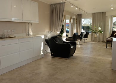 Elegant salon setup at Hair Byizzyangellx in Totton, England, GB, showcasing modern design and styling stations.