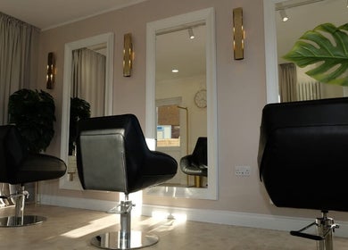Elegant styling chairs in Hair Byizzyangellx salon, Totton, England, GB, with large mirrors and lush decor.
