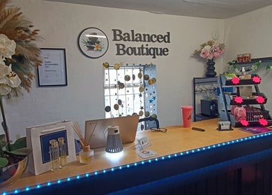 Reception desk at Balanced Boutique, Newtownards, with flowers and decor.
