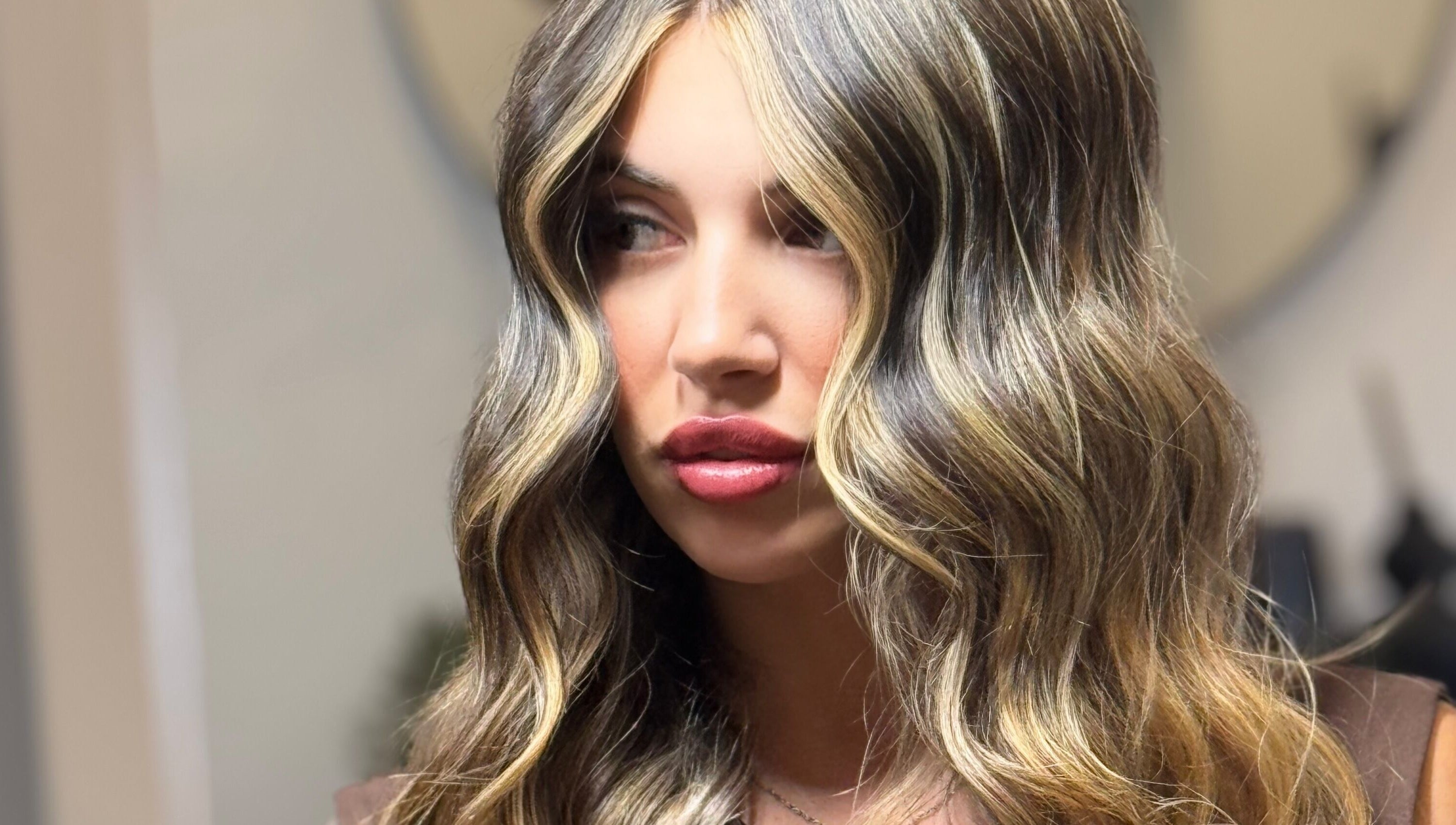 Woman with wavy blonde hair at Kiah Lopez Beauty, Gibraltar, GI.