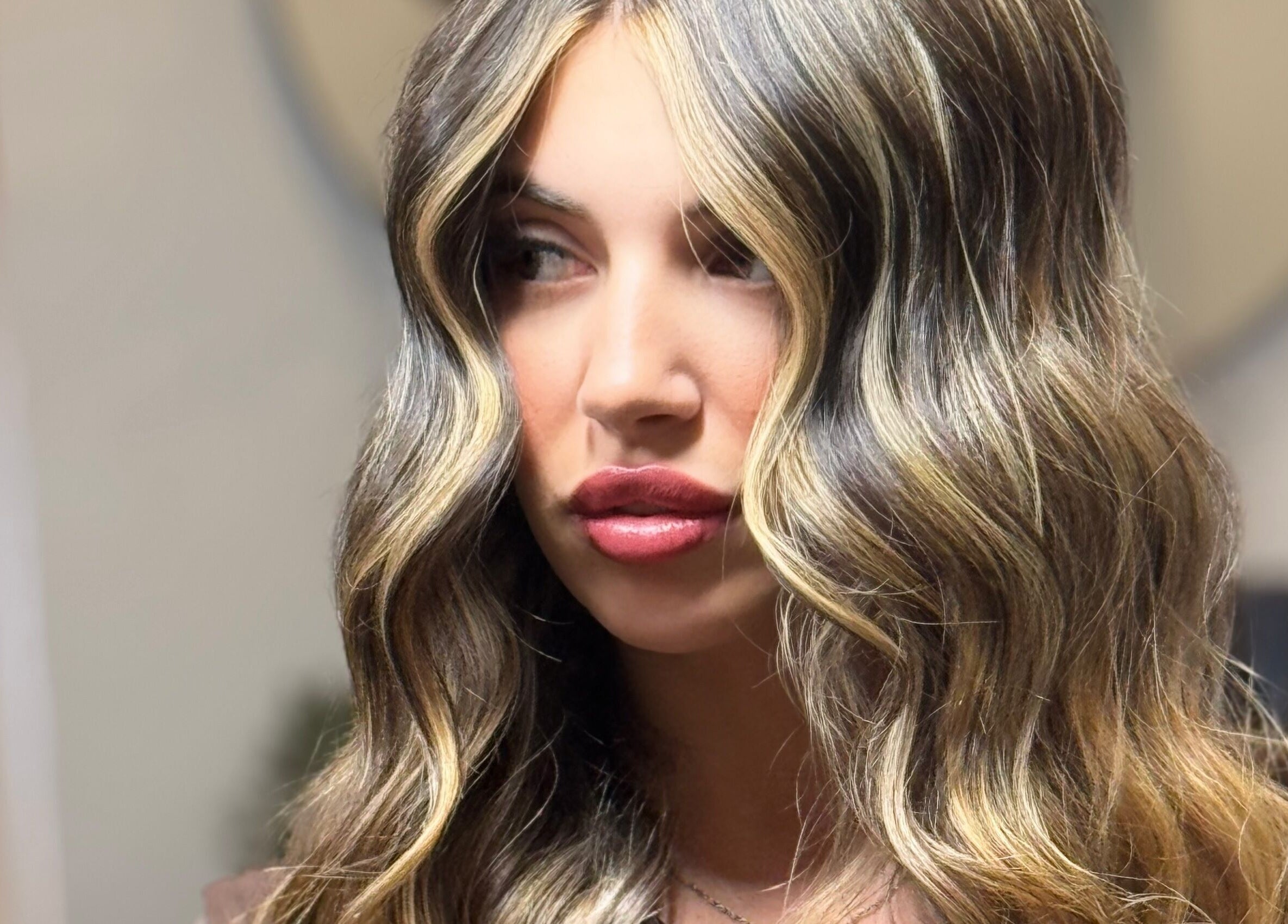 Woman with wavy blonde hair at Kiah Lopez Beauty, Gibraltar, GI.