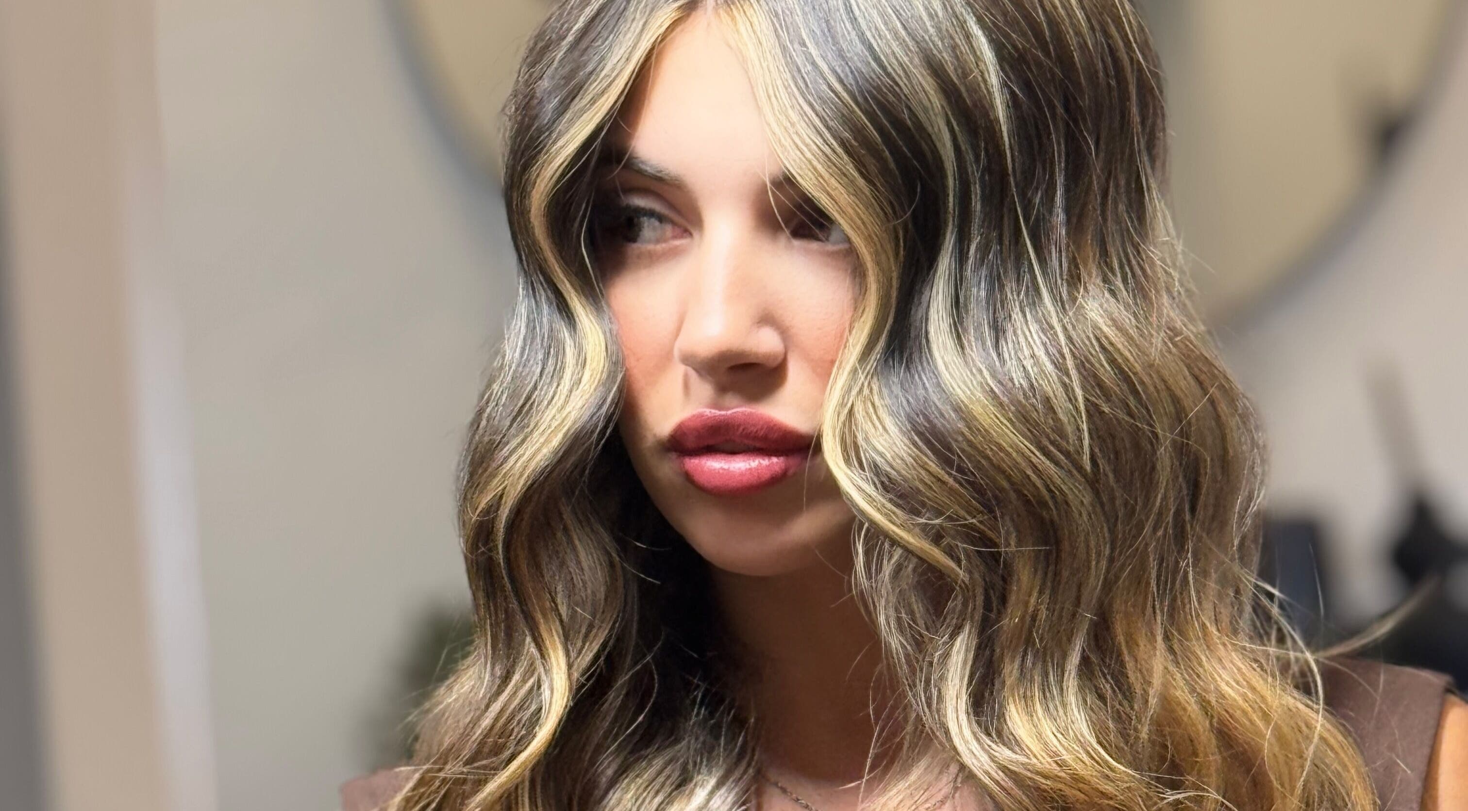 Woman with wavy blonde hair at Kiah Lopez Beauty, Gibraltar, GI.