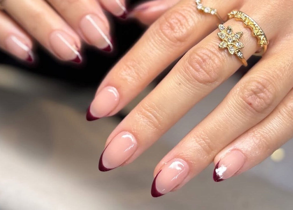 Elegant manicure with burgundy tips at Kiah Lopez Beauty, Gibraltar, GI.
