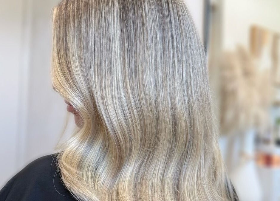 Elegant blonde waves styled at Kiah Lopez Beauty, a premier salon in Gibraltar, GI.