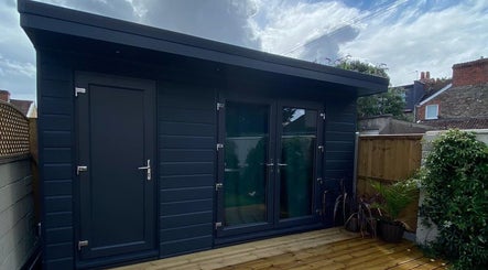 Exterior of Massage for Life by Catherine Newman, Bristol, GB, showing a sleek, modern cabin for relaxation.