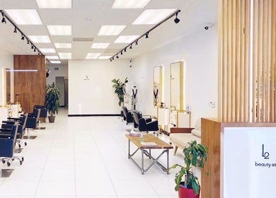 Modern interior of L2 hair salon in Millbrae, California, US with stylish decor and sleek salon chairs.