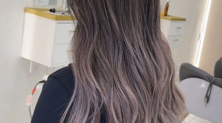 Elegant wavy hairstyle at L2 hair salon, Millbrae, California, US, showcasing beautiful color and texture.