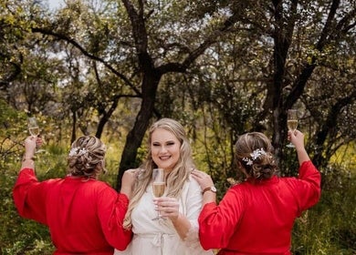 Bridal party at Style Journey Hair Salon in Pretoria, Gauteng, ZA celebrates outdoors with champagne.