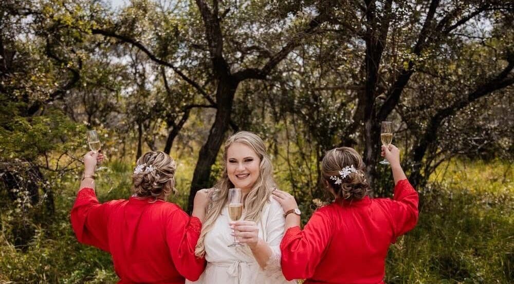 Bridal party at Style Journey Hair Salon in Pretoria, Gauteng, ZA celebrates outdoors with champagne.