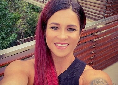 Smiling person with vibrant hair on balcony at Style Journey Hair Salon, Pretoria, Gauteng, ZA.