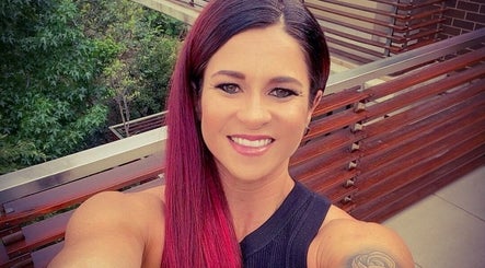 Smiling person with vibrant hair on balcony at Style Journey Hair Salon, Pretoria, Gauteng, ZA.